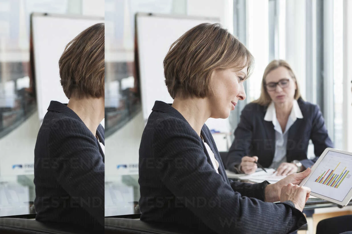 Businesswoman using digital tablet in a meeting